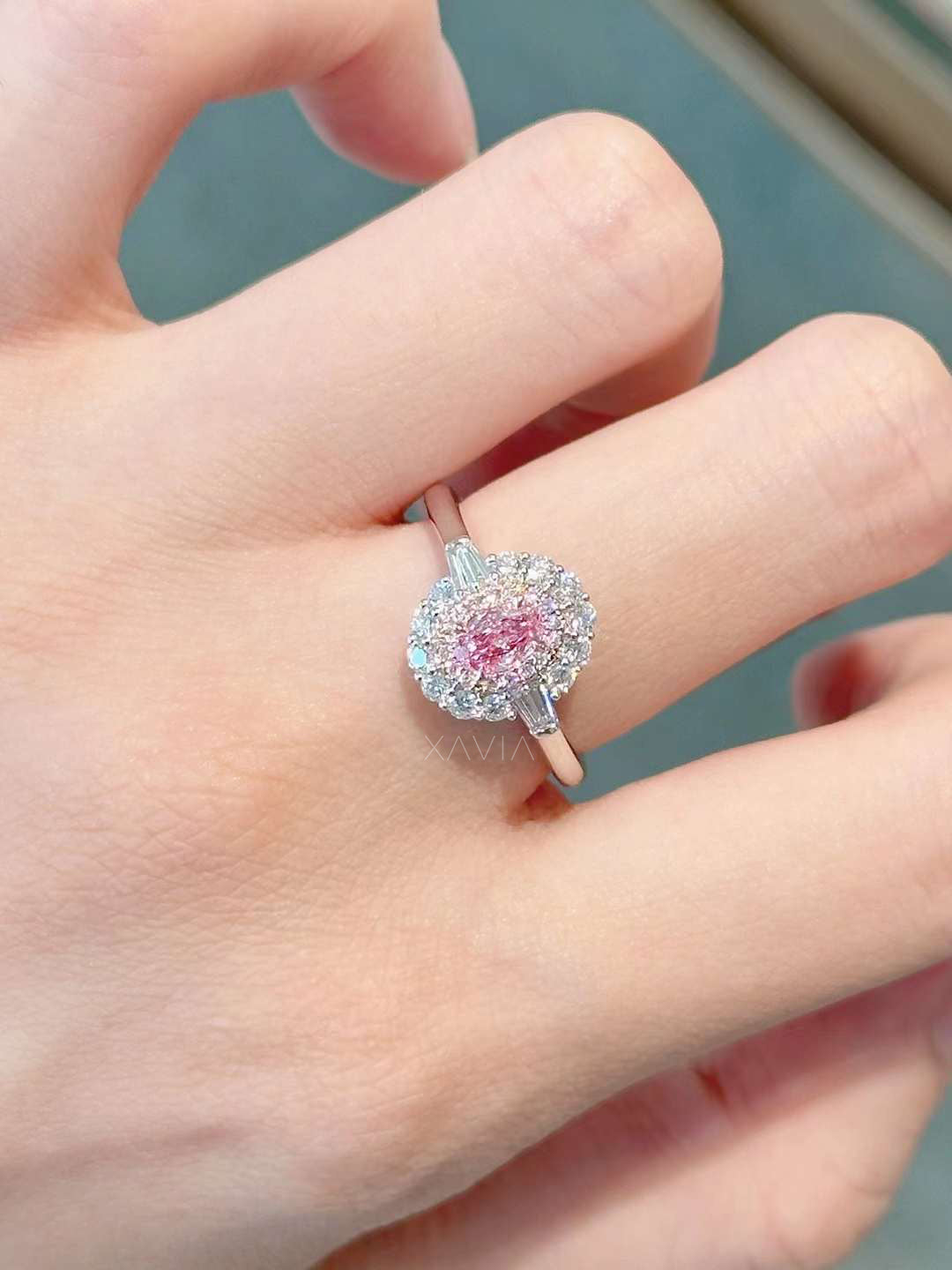 pink oval diamond ring with floral-inspired double halo worn on hand, showcasing elegance
